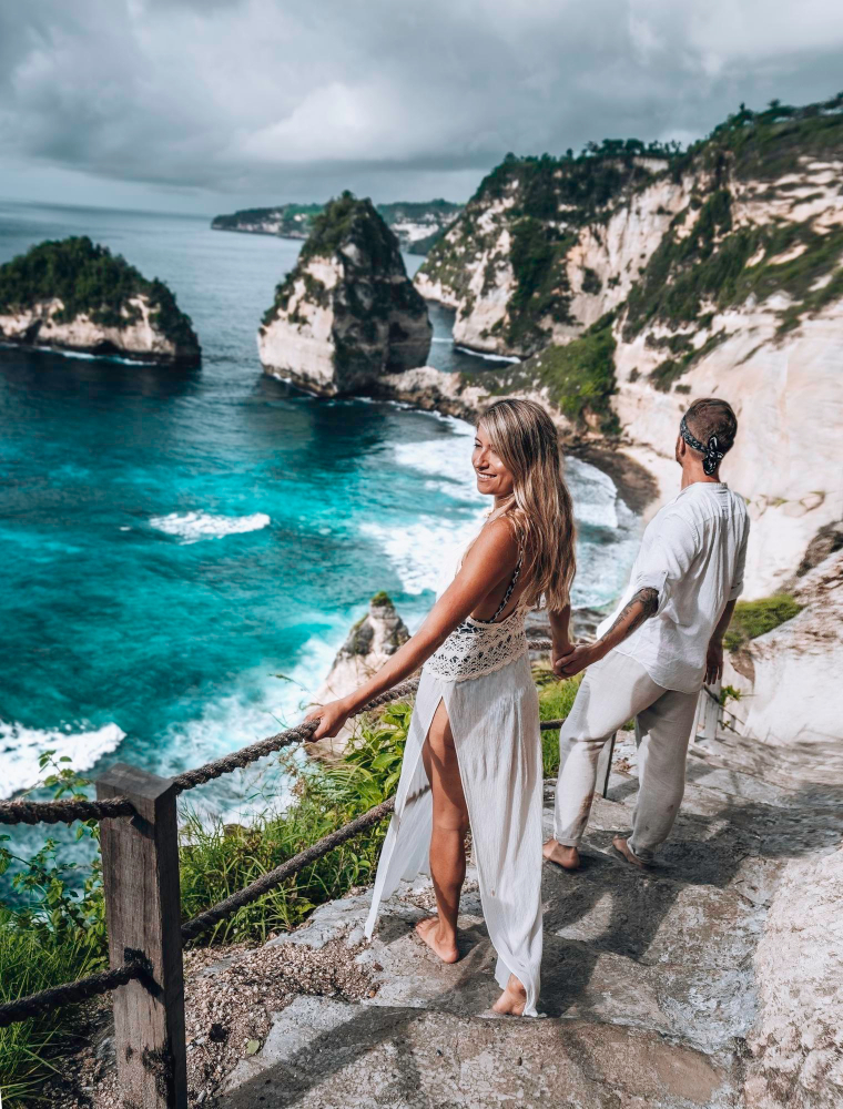 A couple at the famous diamond beach of nusa penida bali
